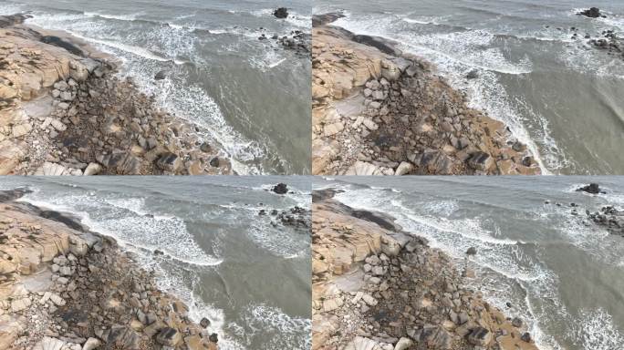 阴天海水沙滩航拍礁石海岸石头俯拍海上岩石