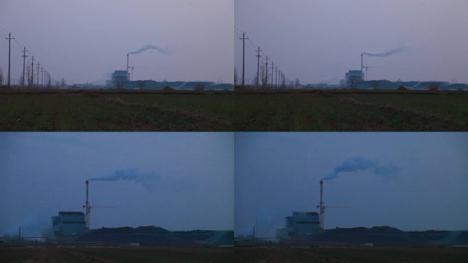 黄昏郊野外一座工厂烟囱冒着白烟电影质感