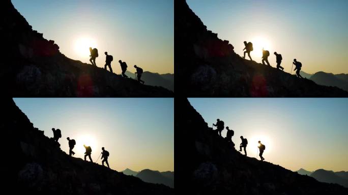 团队登山剪影攀登顶峰逆光爬山人物剪影行者