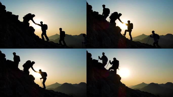 手拉手登山剪影团队精神逆光爬山攀登顶峰