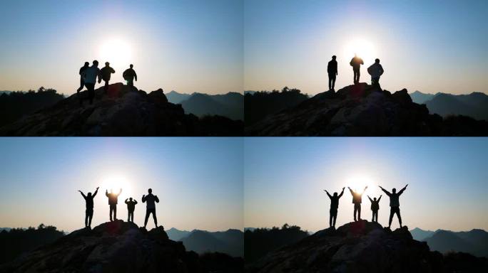 团队登山剪影山顶举手欢呼成功登顶攀登顶峰