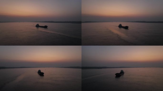 日落余晖下长江江面上跟拍过往的轮船运沙船