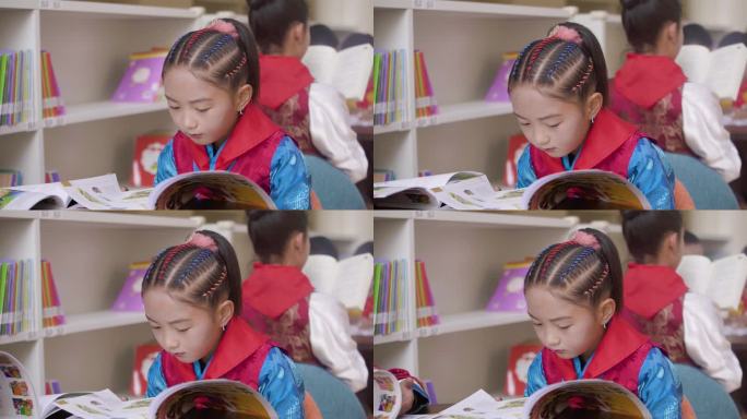 小学生戴耳坠小学生穿民族服饰藏族学生看书