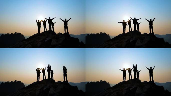 团队山顶举手欢呼拥抱太阳成功登顶团队精神