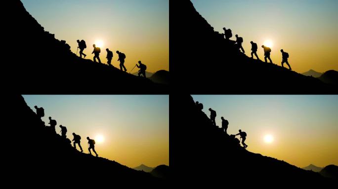 一群人登山剪影团队精神攀登山峰逆光行走
