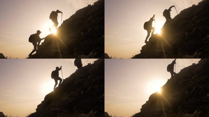 登山登山行者正在迎着阳光逆光成功攀登高峰