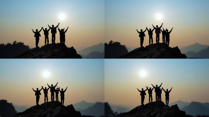 一群人山顶举手欢呼张开双臂拥抱太阳攀登者