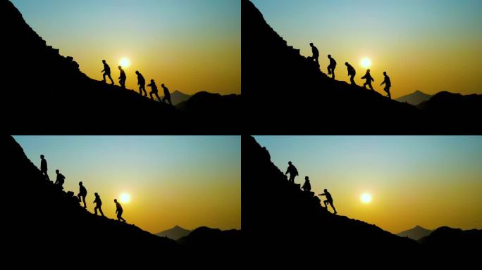 团队登山剪影逆光爬山团队精神团队走向山顶