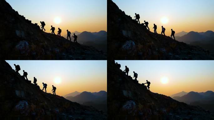 团队爬山剪影登山运动团队逆光行走攀登山峰