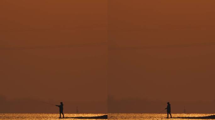 长江边橙色的夕阳下钓鱼者甩竿钓鱼竖屏