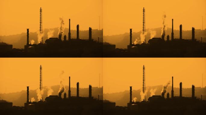 4k夕阳黄昏下的工厂工业烟囱能源排放