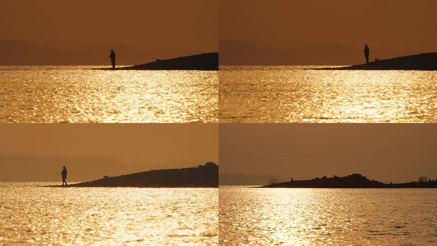 长江边橙色的阳光下钓鱼者甩竿钓鱼波光粼粼