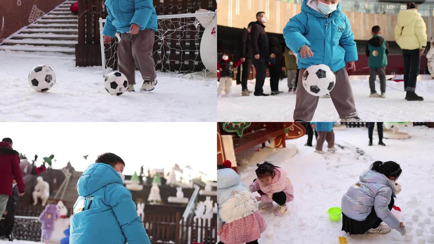 小孩子在雪地里玩耍踢足球