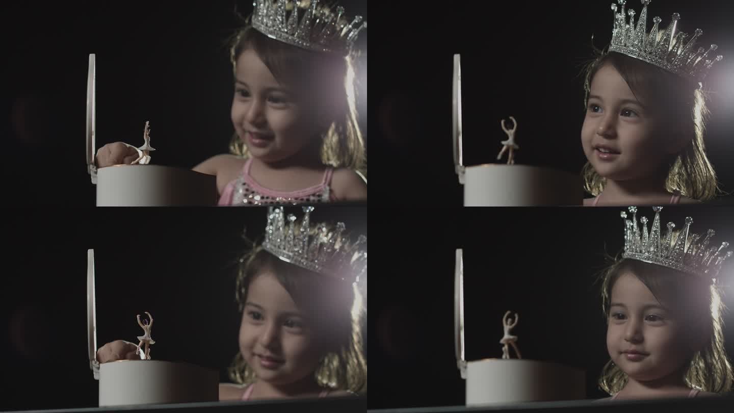 小女孩看八音盒上跳芭蕾的小人