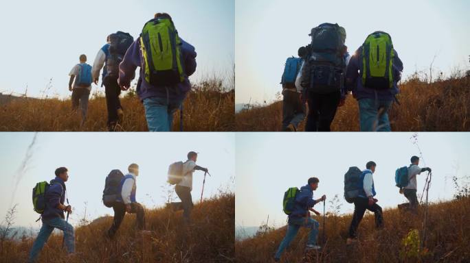 一群人登山背影逆光奔跑山顶行走背包客徒步