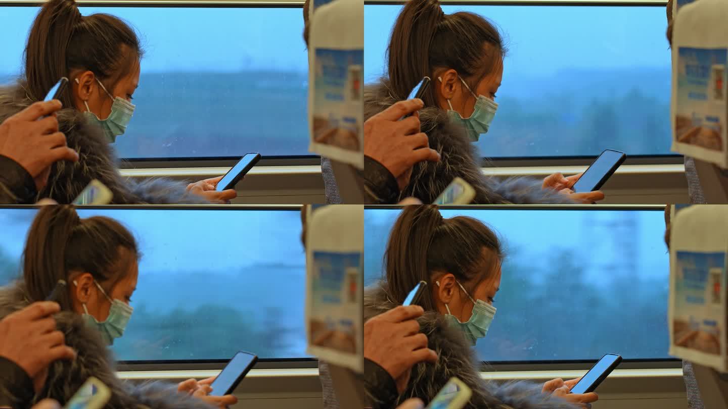 高铁上刷手机的女孩