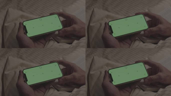 坐在床上看绿屏手机