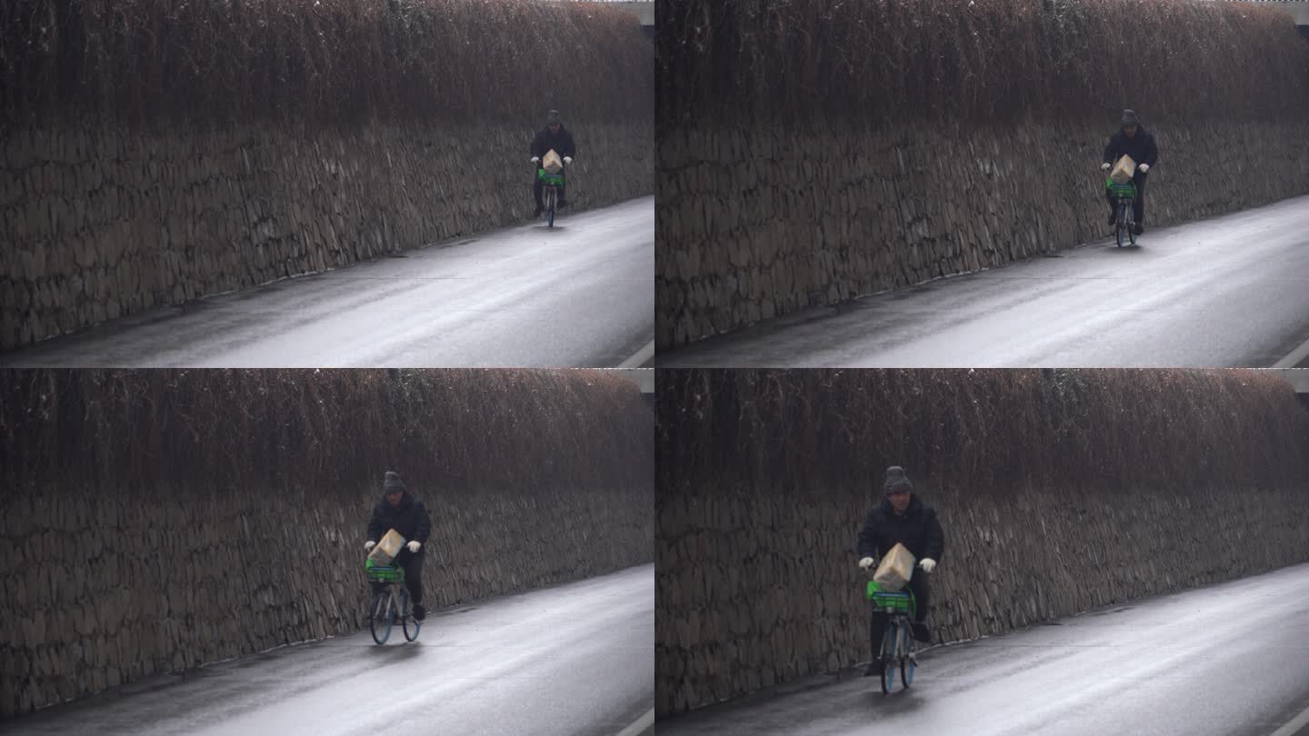 冬季一位戴着帽子的老人骑车自行车经过