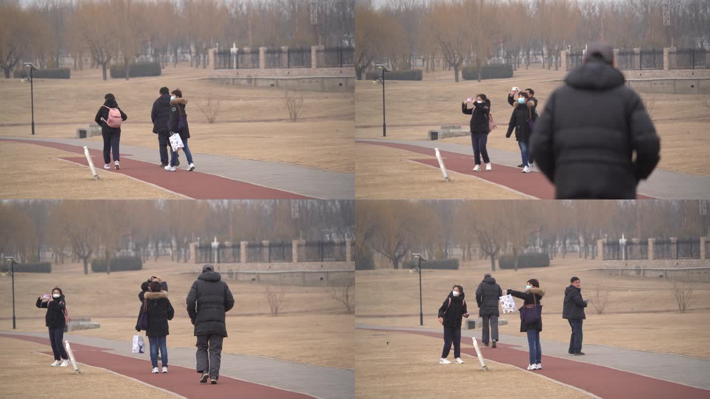 一位老年人跑步的背影几个人举起手机拍照