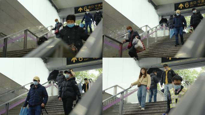 下雨上海地铁进站排队扶梯