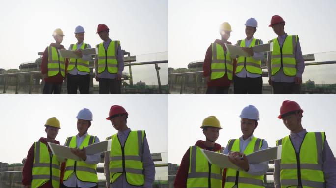 建筑设计师工地查看图纸团队戴着安全帽视察