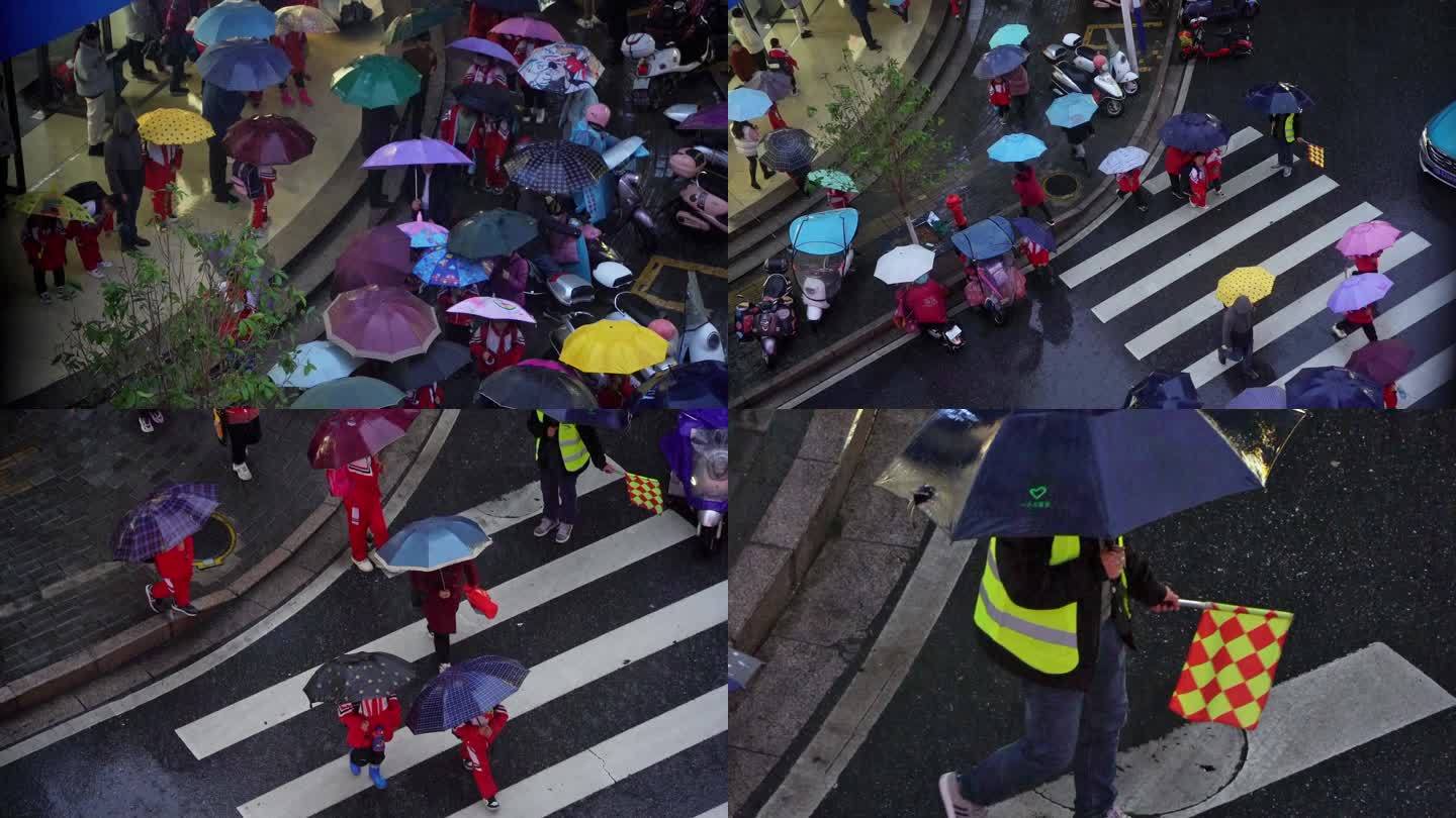 雨天小学生放学打雨伞过马路志愿者维持秩序