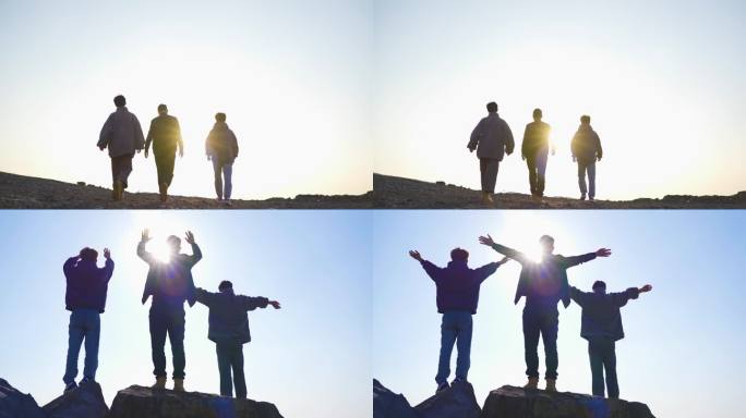 团队登山徒步前进攀登高峰张开双臂拥抱太阳