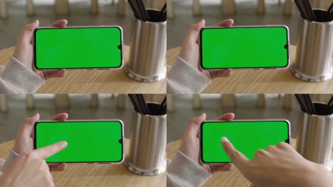 女性拿着绿色屏幕的手机