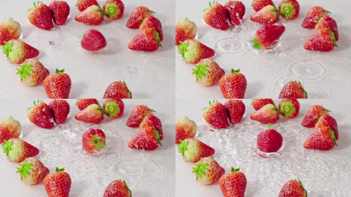 草莓掉落到水中旋转溅起水花