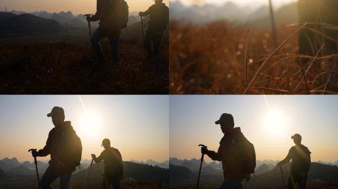 行者登山徒步旅游两名背包客逆光行走在山顶