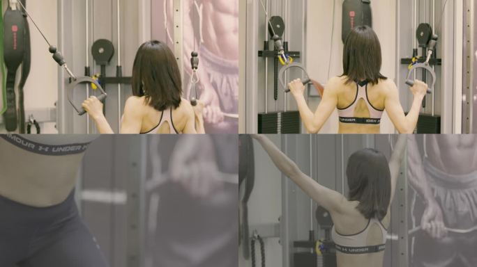 肌肉女健美运动员在健身房使用健身机锻炼