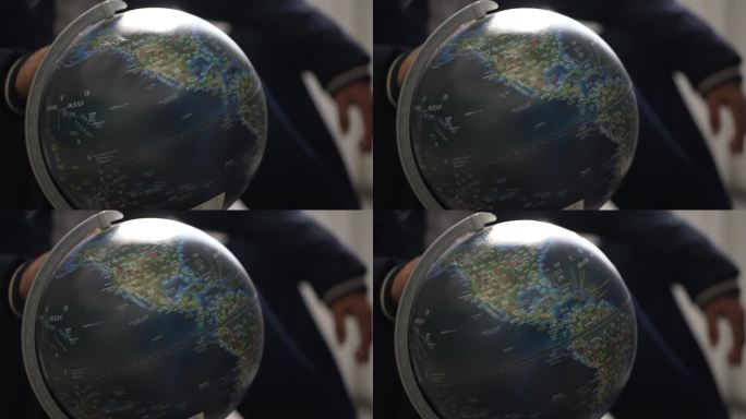 地理老师全球旅行手转动地球仪世界实拍