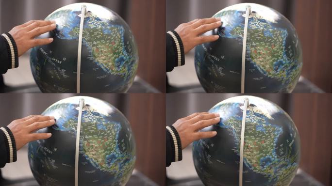 地理老师旅行者手转动地球仪实拍原素材世界