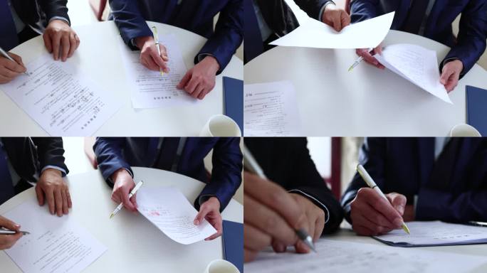 两个签署合同协议和整理文件的商人