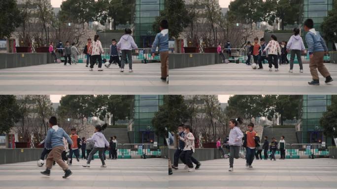 一群小孩子在广场上踢球