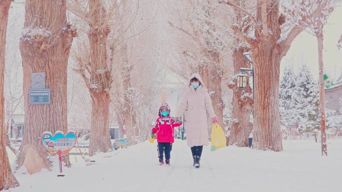 4K冬季下雪妈妈牵手孩子玩雪唯美空镜头