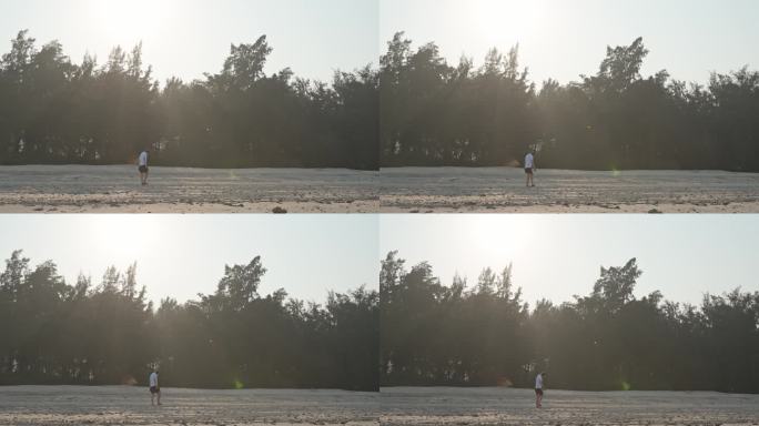 4K正版-逆光下沙滩上散步的人