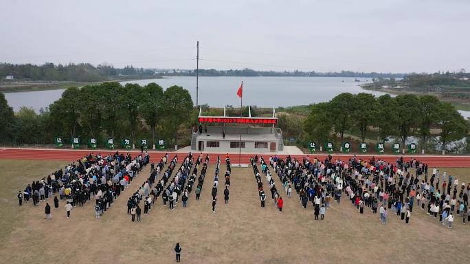 航拍农村学校操场集合学生升旗仪式