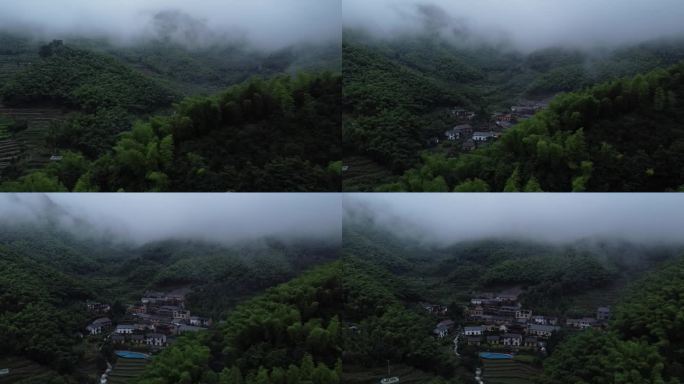 航拍雨天被云雾和竹林环绕的山间农村