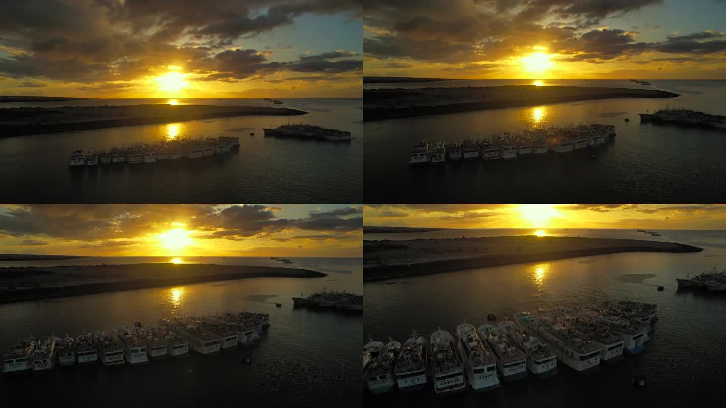 夕阳下整齐排列在海面上的渔船