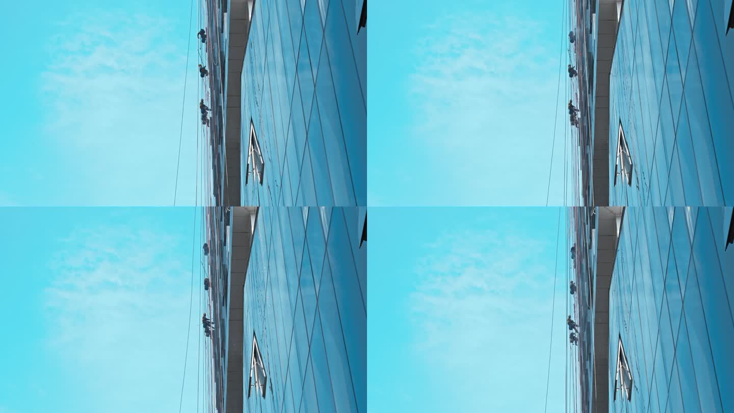 吊在半空中清洗城市高楼玻璃外墙的蜘蛛人