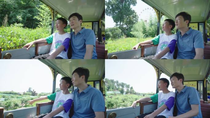 父子俩乘坐景区观光小火车
