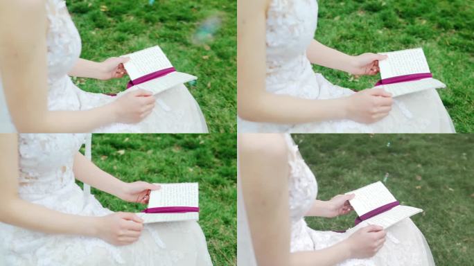 穿着婚纱的新娘子看手里的誓言卡