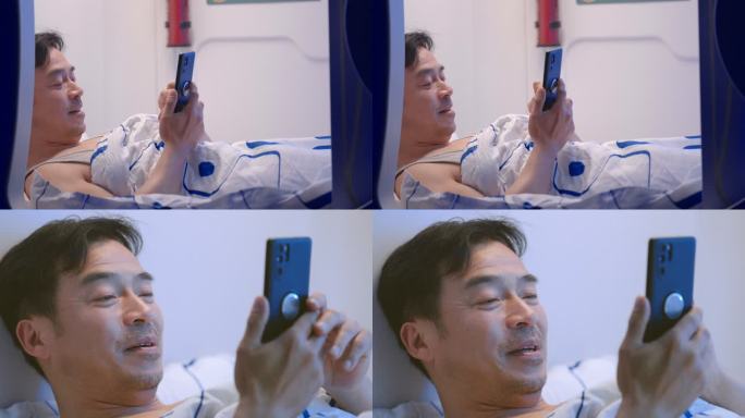 中年男人躺在床上玩智能手机