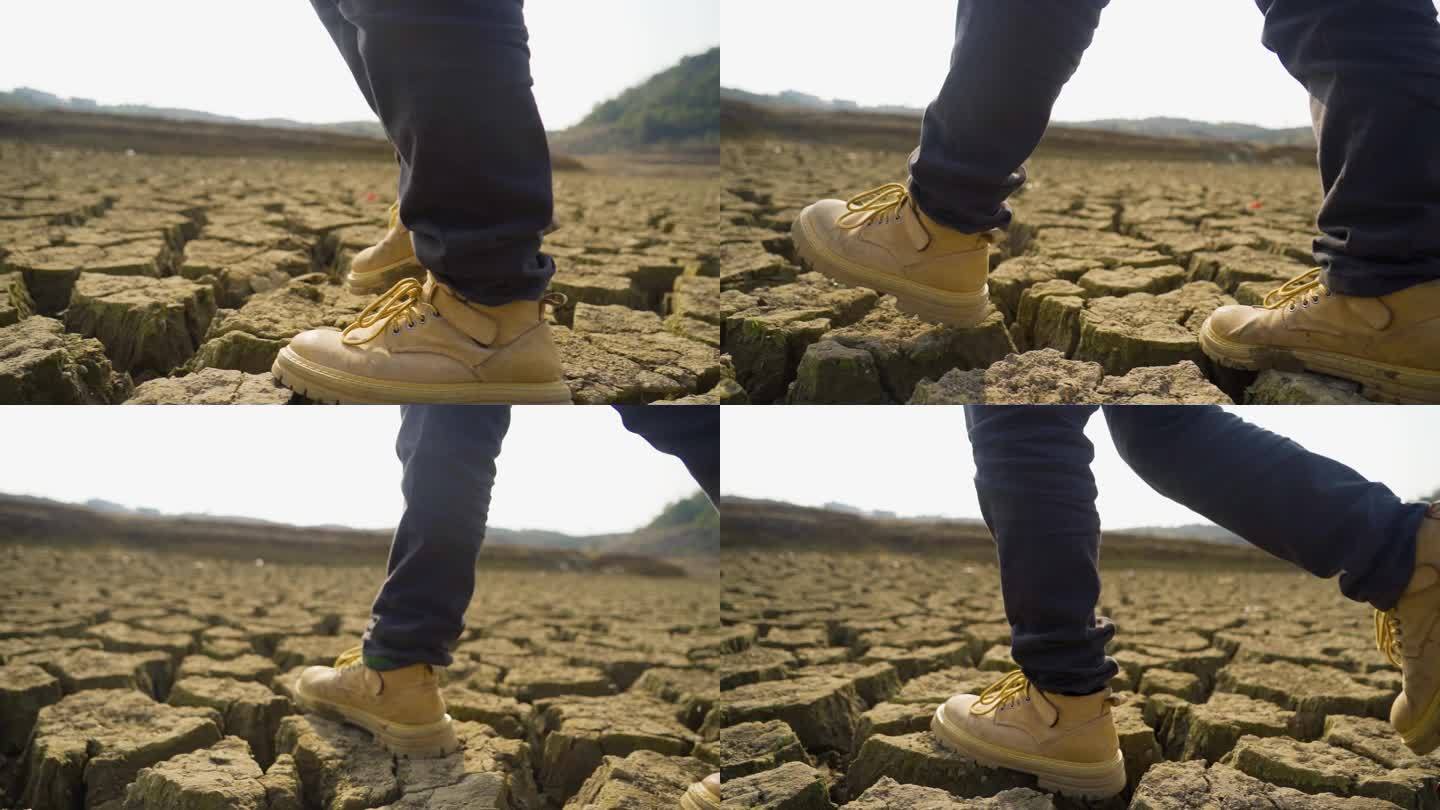 干旱土地行走脚步脚踩裂缝前行保护水资源