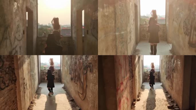 少女站在窗前拍照对着阳光自拍夕阳光影剪影