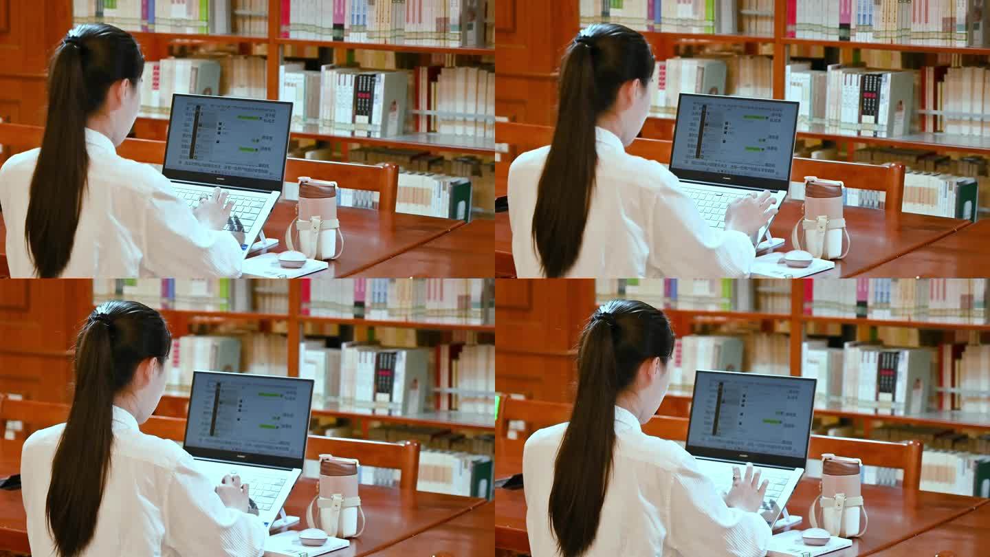 图书馆内正在电脑前工作的女性