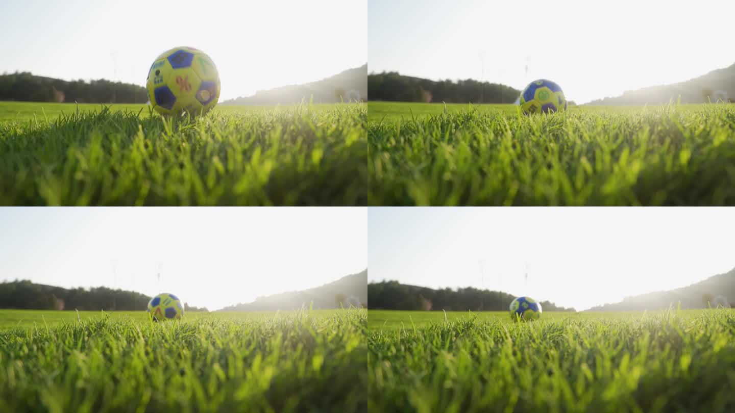 足球落地瞬间草地足球滚动小朋友户外玩足球