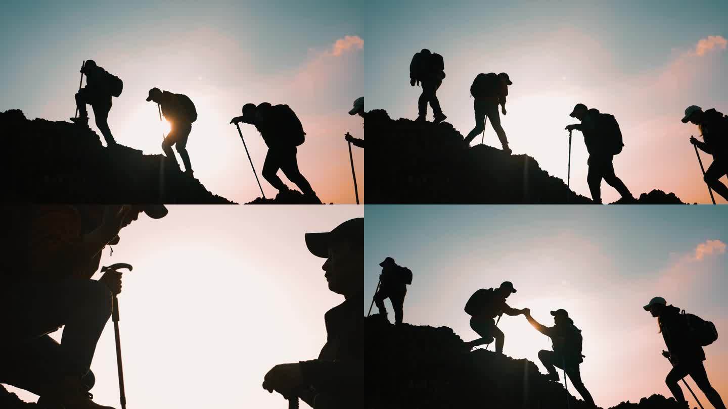 团队手拉手登山同心协力互相鼓励一起登山峰