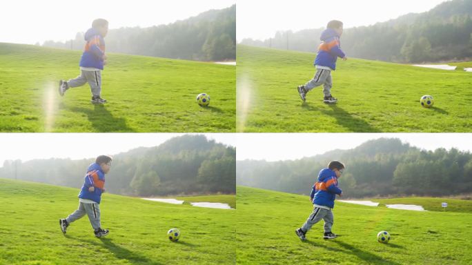 小孩草地踢足球美好童年户外运动家庭教育